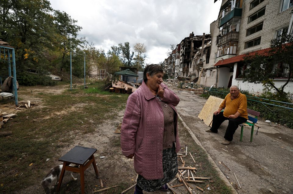A woman reacts as she stands outside a building that was damaged by a Russian missile amid Russias attack on Ukraine, in Svyatohirsk, in Donetsk region, Ukraine, October 3, 2022.