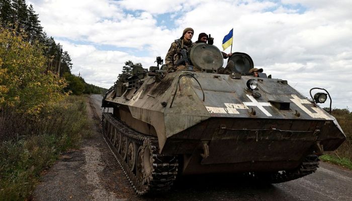 Ukrainians ride an armoured vehicle, amid Russias attack on Ukraine, in Donesk region, Ukraine, October 3 2022.— Reuters