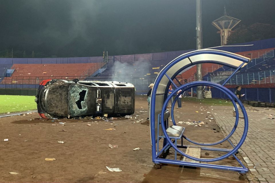 A damaged car is pictured following a riot after the league BRI Liga 1 football match between Arema vs Persebaya at Kanjuruhan Stadium, Malang, East Java province, Indonesia, October 2, 2022, in this photo taken by Antara Foto.