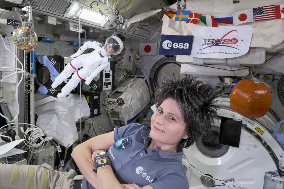 A handout picture shows Europes first female commander of the ISS, ESA astronaut Samantha Cristoforetti with her lookalike Barbie doll at the International Space Station (ISS). — Reuters