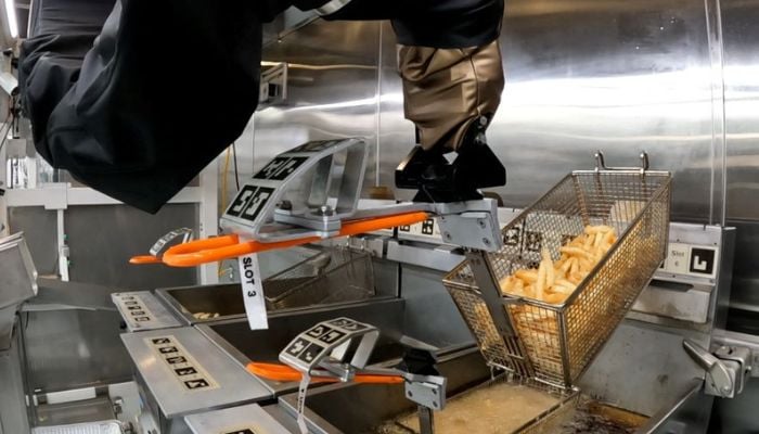 The Flippy 2 robot takes fries out of a vat of oil at a lab of manufacturer Miso Robotics Inc in Pasadena, California, U.S. September 27, 2022, in this screen grab from a REUTERS video.
