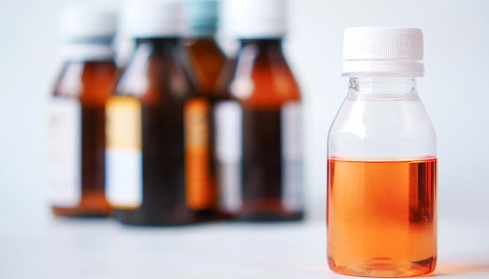 A representative image of cough syrup bottles. — Unsplash