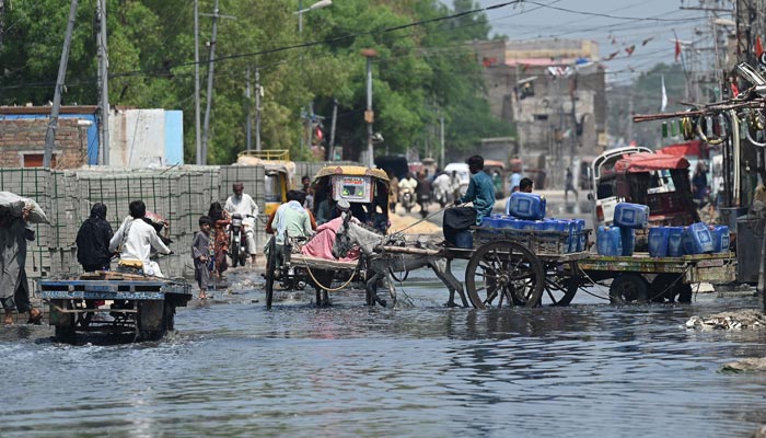 A representational image of people struggling after floods. — AFP