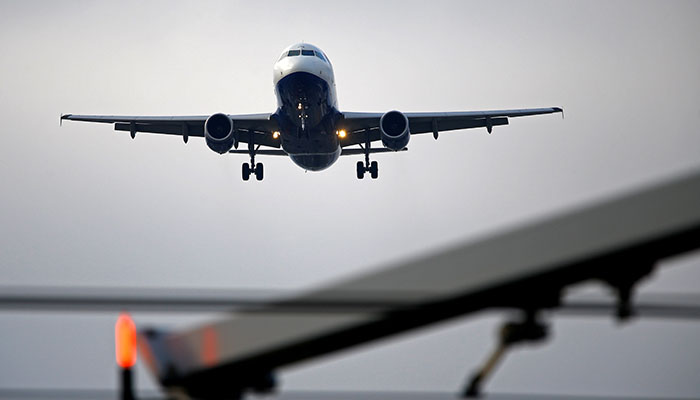 An airplane prepares to land at Cointrin airport in Geneva, Switzerland December 5, 2017. — Reuters