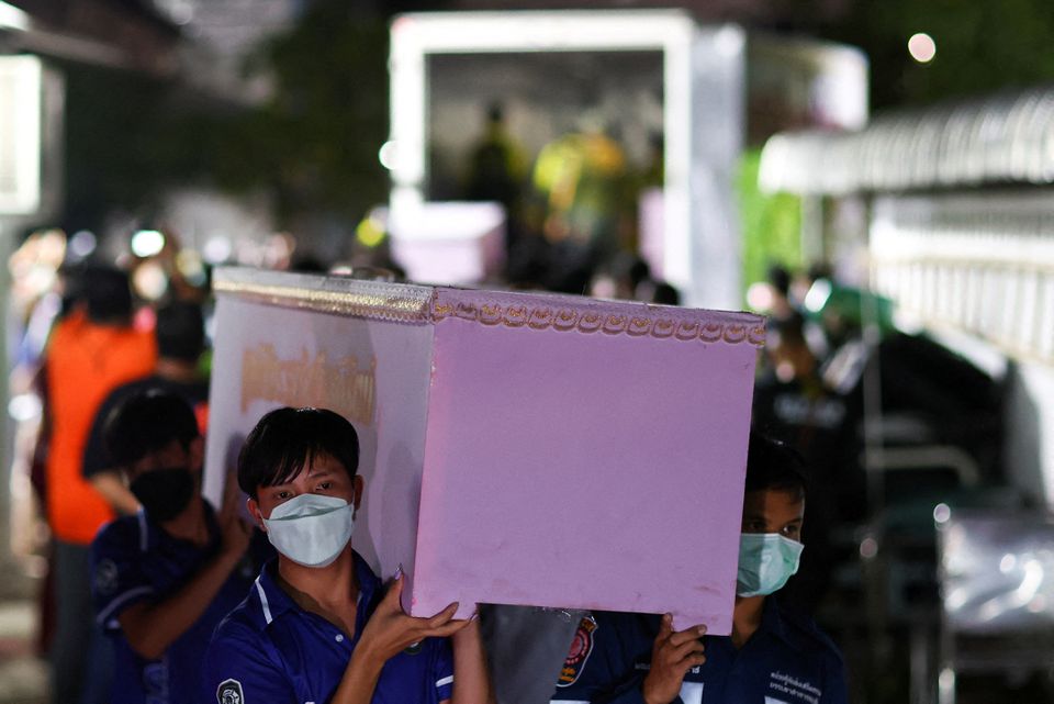 Rescue workers carry a coffin containing the body of a victim at Udon Thani hospital in Udon Thani province, following a mass shooting in the town of Uthai Sawan, around 500 km northeast of Bangkok in the province of Nong Bua Lam Phu, Thailand October 7, 2022.