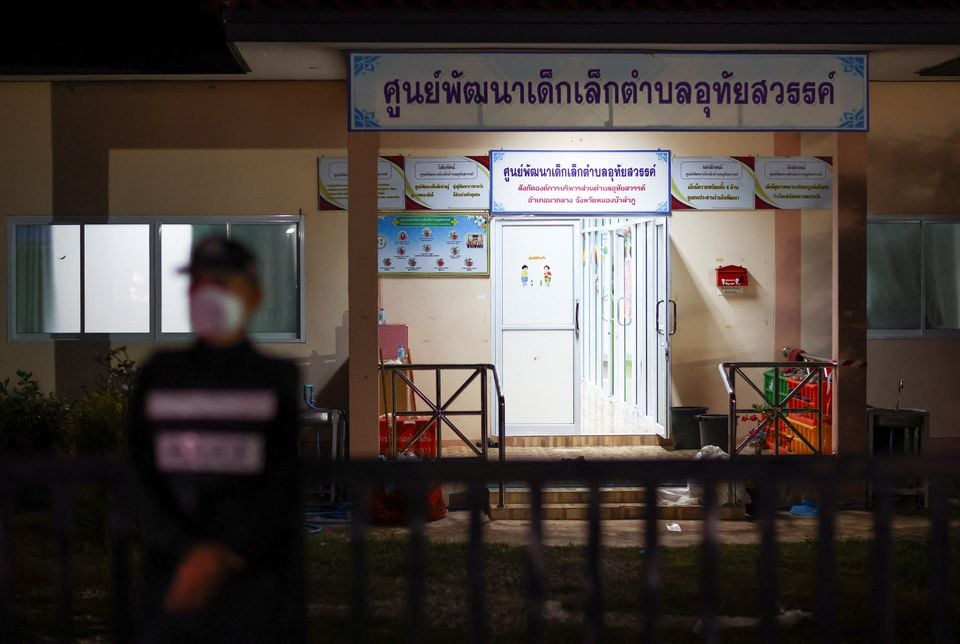 A police officer stands guard outside a day care center which was the scene of a mass shooting, in the town of Uthai Sawan, around 500 km northeast of Bangkok in the province of Nong Bua Lam Phu, Thailand October 6, 2022.
