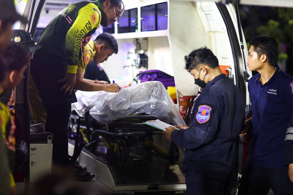 Rescue workers stand next to the body of a shooter Panya Khamrap at Na Klang Hospital following a mass shooting, in the town of Uthai Sawan, around 500 km northeast of Bangkok in the province of Nong Bua Lam Phu, Thailand October 6, 2022.