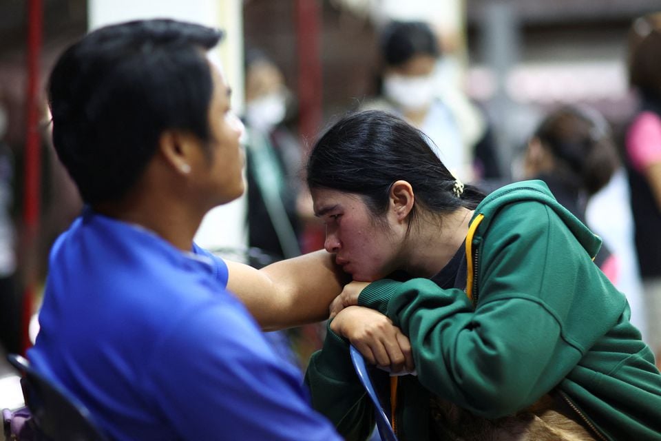 People gather outside a day care center which was the scene of a mass shooting, in the town of Uthai Sawan, around 500 km northeast of Bangkok in the province of Nong Bua Lam Phu, Thailand October 6, 2022.