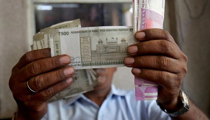 A cashier checks Indian rupee notes inside a room at a fuel station in Ahmedabad, India, September 20, 2018. — Reuters/File