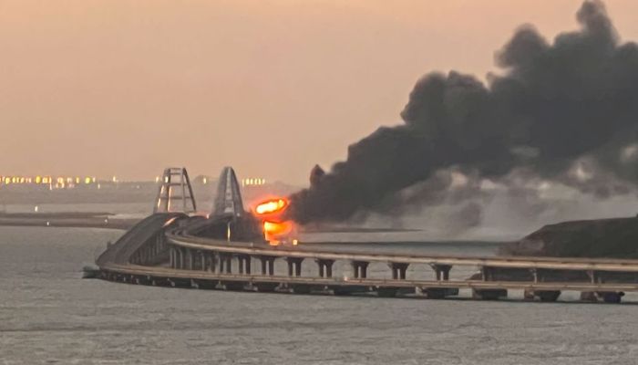 A view shows a fire on the Kerch bridge at sunrise in the Kerch Strait, Crimea, October 8, 2022. —  Reuters