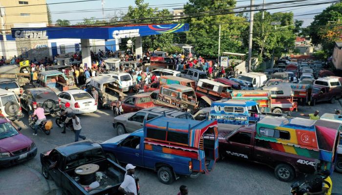 People crowd around a petrol station after a group of Haitian gangs temporarily lifted a blockade leading to fuel shortages, in Port-au-Prince, Haiti November 14, 2021.— Reuters