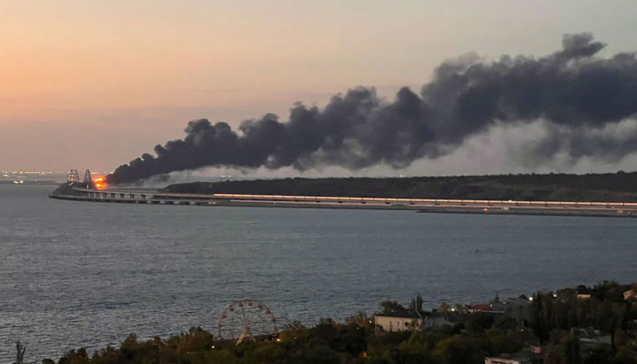 A view shows a fire on the Kerch bridge at sunrise in the Kerch Strait, Crimea, October 8, 2022.
