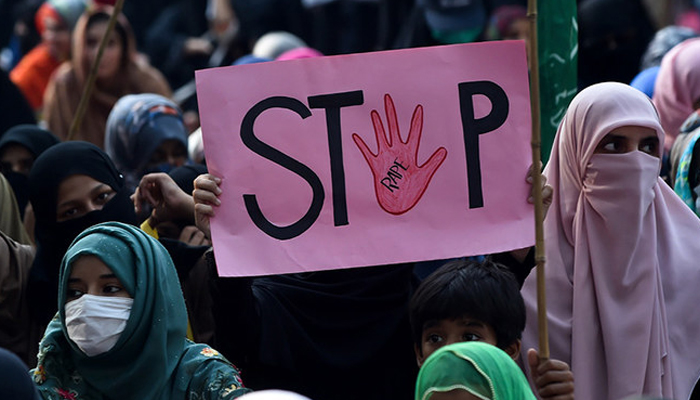 A person holds a placard reading stop rape during a protest against alleged gang rape of a woman, in Lahore on September 17, 2020. — AFP/File