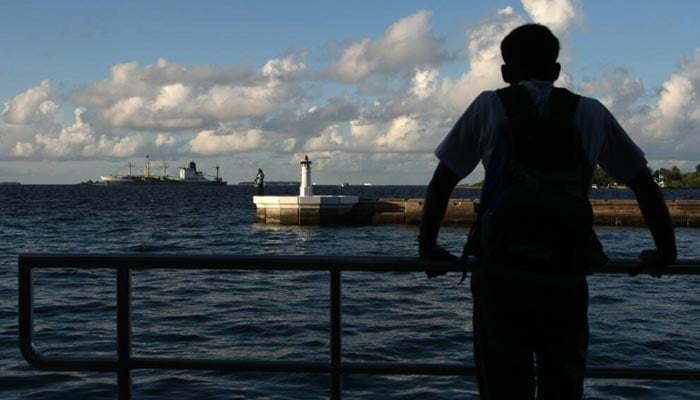 A man looks out to sea in October 2008 in Male, the capital of the Maldives. — AFP/File