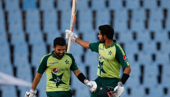 Pakistan´s captain Babar Azam (R) celebrates after scoring a century (100 runs) as Pakistan´s Mohammad Rizwan (L) looks on during the third Twenty20 international cricket match between South Africa and Pakistan at SuperSport Park in Centurion on April 14, 2021. — AFP