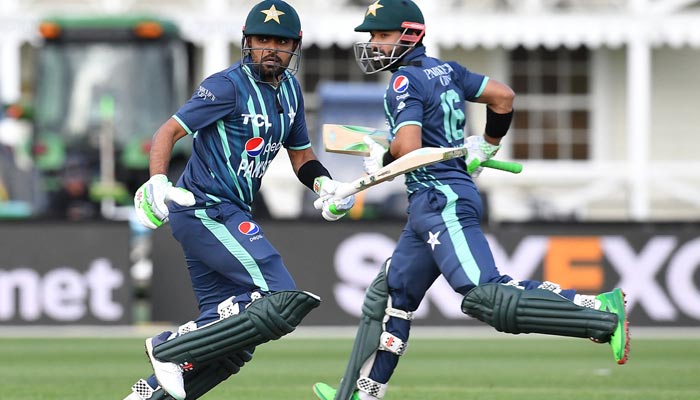 Pakistans Babar Azam (L) and Mohammad Rizwan run between the wickets during the T20 tri-series cricket match between Pakistan and Bangladesh at Hagley Oval in Christchurch on October 13, 2022. — AFP