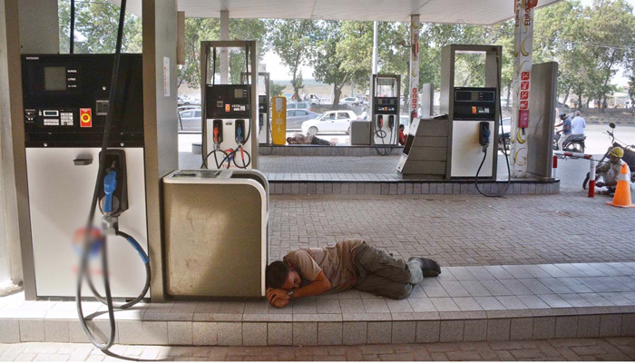 A gas station worker takes a nap in Karachi as a major power breakdown took place on Thursday plunging large parts of the country into darkness. APP/SDQ/ABB