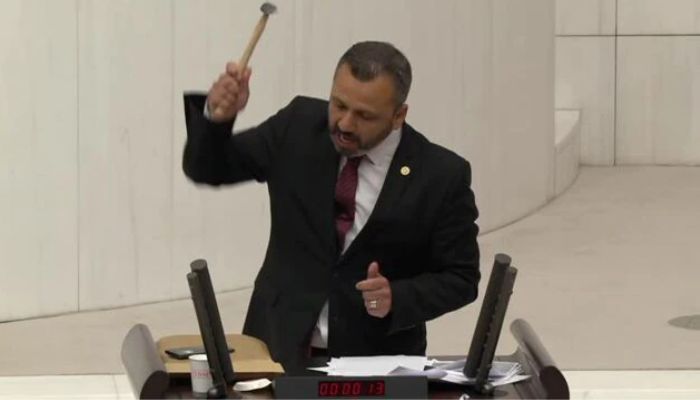 Burak Erbay, a member of the main opposition Peoples Republican Party, took out a hammer from a bag and started smashing the cell phone.— Screengrab via Reuters video