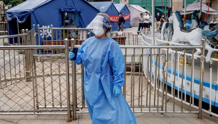 A medical worker in personal protection suit stands at a nucleic acid testing station, following the coronavirus disease (COVID-19) outbreak, in Beijing, China, June 16, 2022.— Reuters
