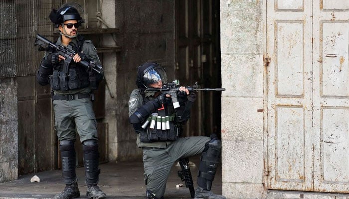 A member of the Israeli forces aims his weapon amid clashes with Palestinians during a protest in Hebron in the Israeli-Occupied West Bank October 14, 2022. — Reuters