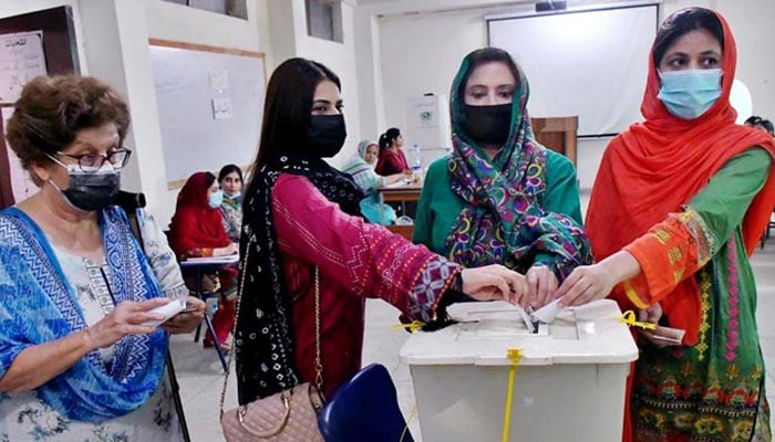 Women can be seen casting votes. — AFP/File