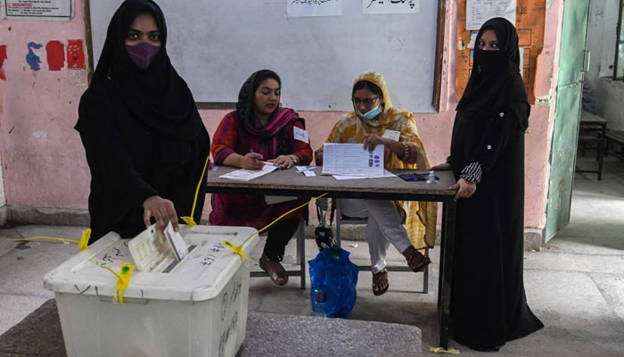 Women can be seen casting votes. — AFP/File