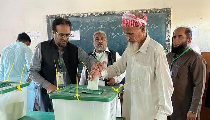 An elderly man casts his vote in Karachis NA-237 Malir. — Twitter/ECP Spokesperson/@HaroonS2021