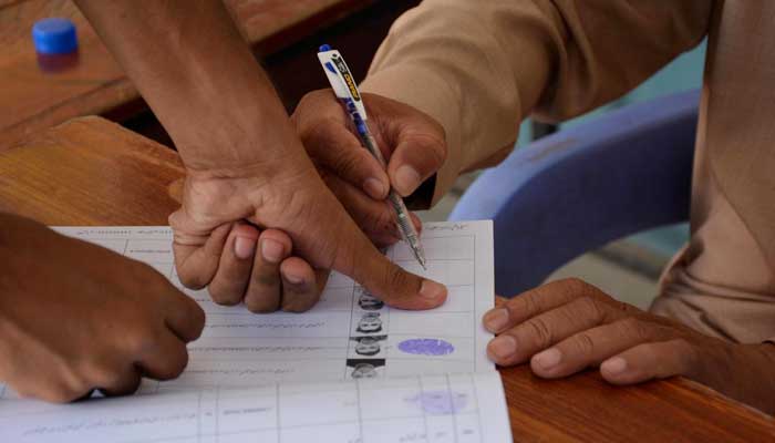 A voter casts his vote during by-election in the NA-108 constituency in Faisalabad on October 16, 2022. — APP/File