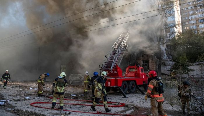 Firefighters help a local woman evacuate from a residential building destroyed by a Russian drone strike, which local authorities consider to be Iranian-made unmanned aerial vehicles (UAVs) Shahed-136, amid Russias attack on Ukraine, in Kyiv, Ukraine October 17, 2022.— Reuters