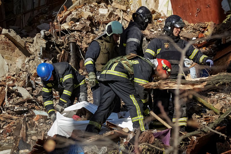 Rescuers extract a body from a residential building destroyed by a Russian drone strike, which local authorities consider to be Iranian-made Shahed-136 unmanned aerial vehicles (UAVs), amid Russias attack on Ukraine, in Kyiv, Ukraine October 17, 2022.