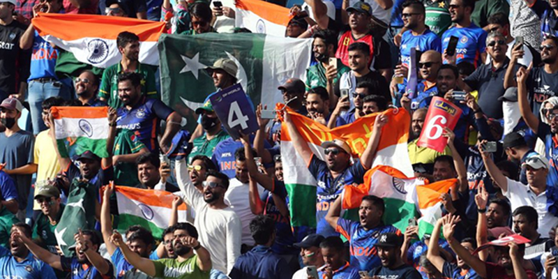 Fans of both teams are pictured with flags inside the Dubai International Stadium before the between India and Pakistan. — Reuters