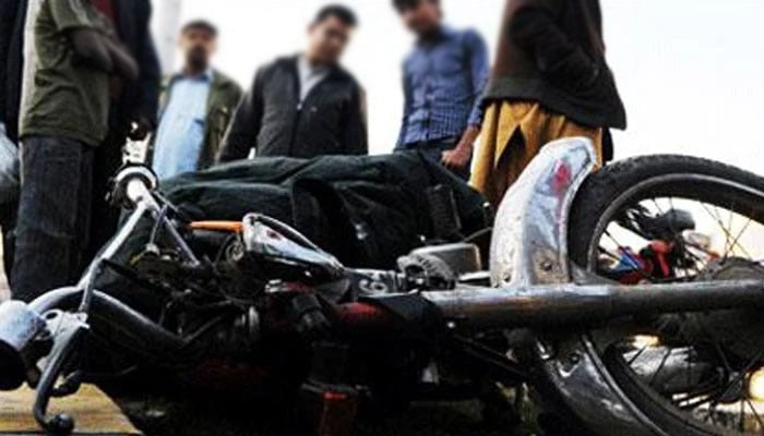 People are looking at the motorbike of a commuter. —AFP/ File