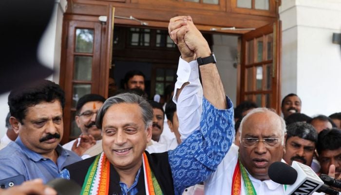 Mallikarjun Kharge, newly elected president of the Congress party, Indias main opposition party, raises his hand with party colleague Shashi Tharoor at Kharge’s residence in New Delhi, India, October 19, 2022.— Reuters
