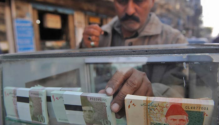 Rupee continues to sink against dollar, loses 1.16 - Financeupdates 2 A vendor arranges 10 and 20-rupee Pakistani bank notes in a display shelf at a commercial area in Karachi, Pakistan, on December 14, 2011. — AFP/File