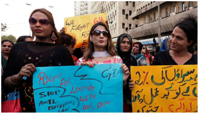 Members of the transgender community hold signs against the anti-begging law for the transgender community, during a protest demanding jobs in Karachi, Pakistan on April 10, 2019. — Akhtar Soomro / Reuters
