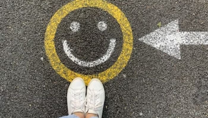 A smiley face painted on the road.— Unsplash