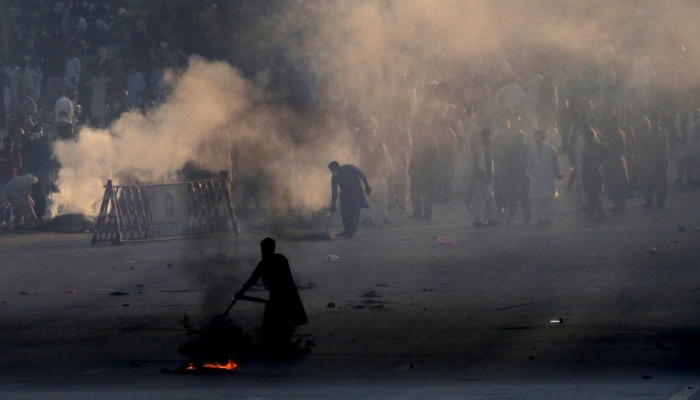 Police use teargas to disperse protestors of Pakistan Tehreek-e-Insaf (PTI) during a demonstration against the decision to disqualify former prime minister Imran Khan from running for political office, in Islamabad on October 21, 2022. — AFP