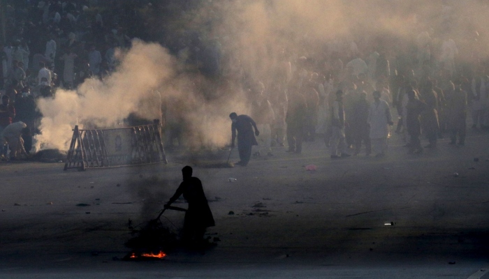 Police use teargas to disperse protestors of Pakistan Tehreek-e-Insaf (PTI) during a demonstration against the decision to disqualify former prime minister Imran Khan from running for political office, in Islamabad on October 21, 2022.— AFP