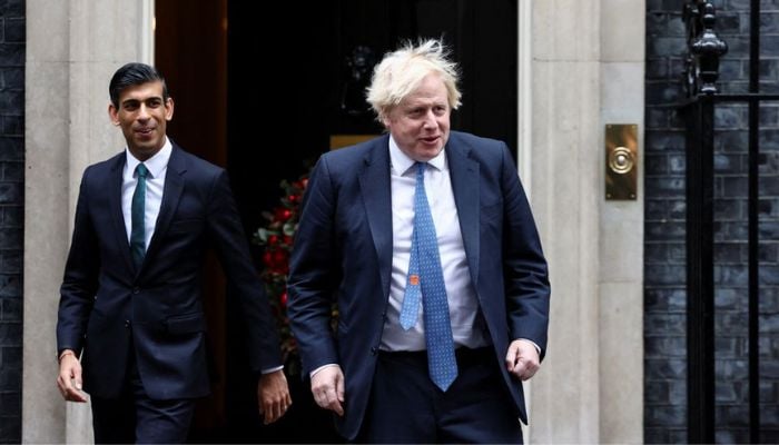 Boris Johnson and Rishi Sunak walk out of Downing Street, in London, Britain, December 1, 2021.— Reuters