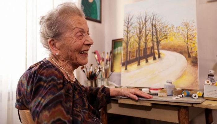 Nada Rudan, a 100-year-old self-taught Bosnian painter, speaks with a journalist during an interview in her home in Sarajevo, Bosnia and Herzegovina, October 20, 2022.— Reuters