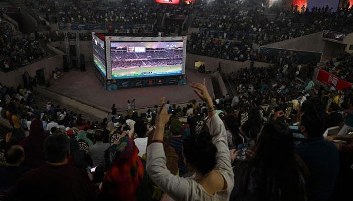 Cricket fans watch the live telecast of the Asia Cup T20 international cricket match between India and Pakistan in Dubai, on big screens in Lahore on August 28, 2022. — AFP/File