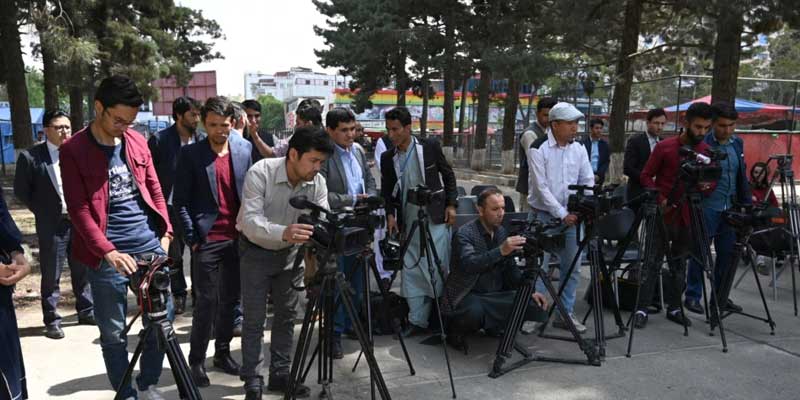Journalists stand with their cameras for coverage of an event in Kabul. — AFP/File