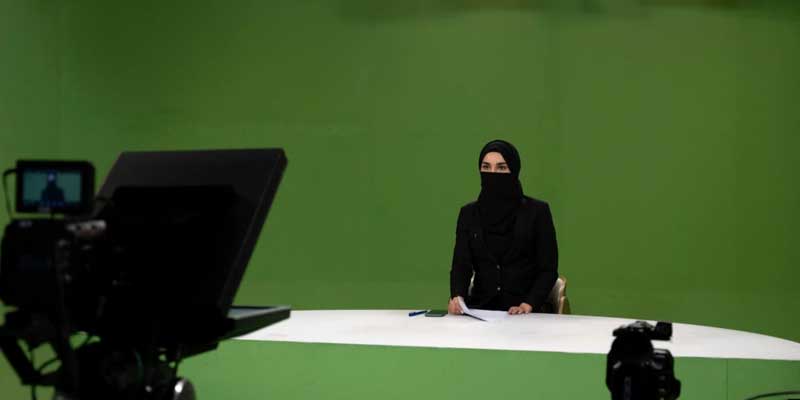 A female journalists reads news wearing a niqab. — AFP/File