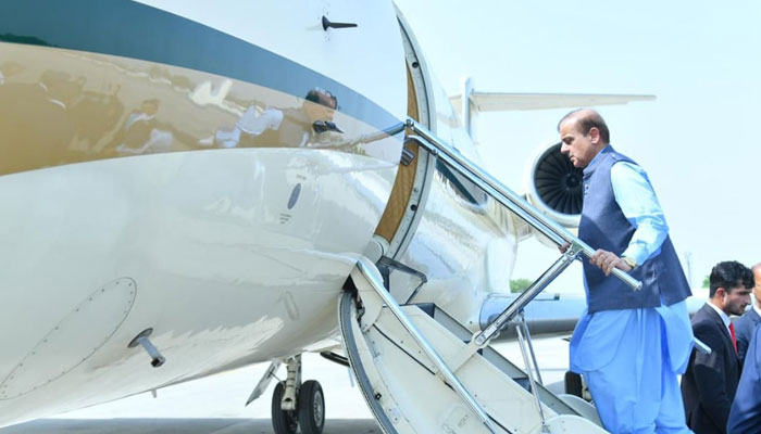 Prime Minister Shehbaz Sharif boarding a Pakistan Air Force plane for an official trip. — Twitter/File