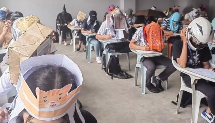 The picture shows college students wearing anti-cheating hats in the Philippines. — Facebook