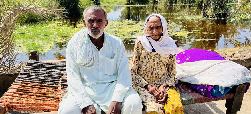Fateh Muhammad, 62, sits with his 85-year-old mother Latifa Khatoon surrounded by stagnant flood water, putting them at great risk of waterborne diseases such as diarrhoea, dysentery, cholera and typhoid as well as being a breeding ground for malaria-carrying mosquitoes. — Helpage