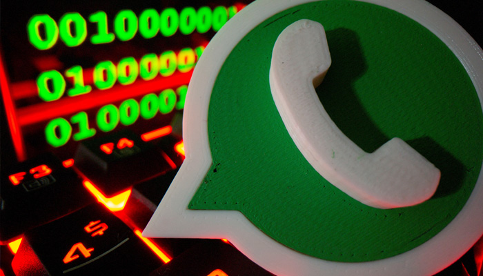 A 3D printed Whatsapp logo is pictured on a keyboard in front of binary code in this illustration taken September 24, 2021. —Reuters
