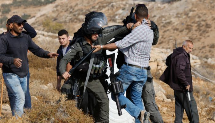 Israeli soldiers detain a Palestinian man during clashes following the demolishing of a Palestinian house in Hebron, in the Israeli-occupied West Bank October 25, 2022.— Reuters