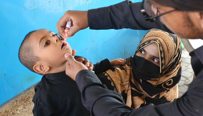 A health worker administering polio drops on a child. — APP/File