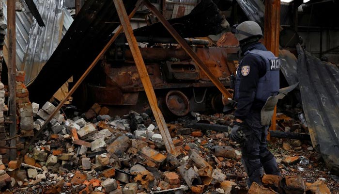 Firefighter Alexander from the de-mining squad of the Ukrainian emergency services enters a burned out tank to search, as they clear an area from shells and other explosive devices, as Russias invasion of Ukraine continues, close to the Russian border in Kazacha Lopan, Ukraine, October 25, 2022. — Reuters